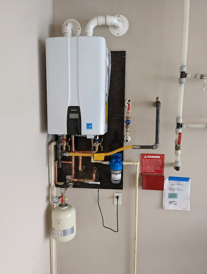 Professional plumber installing copper piping in a Southgate home